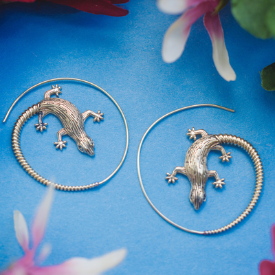 Unique spiral hoop earrings featuring a playful lizard motif.