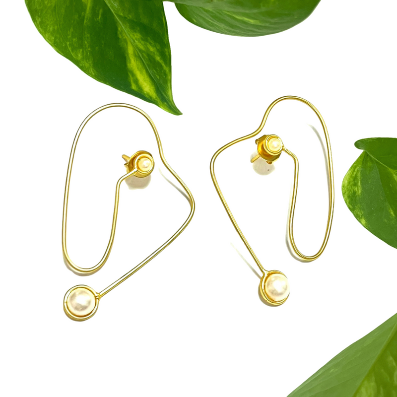 Minimalist gold pearl dangle earrings, perfect for everyday wear or special occasions.