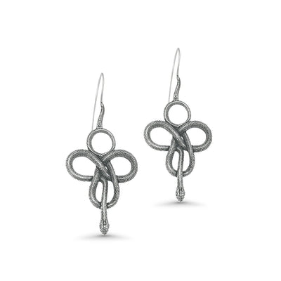 Silver Viking-style snake earrings photographed from side angle, highlighting twisted loop design and antique tribal finish.