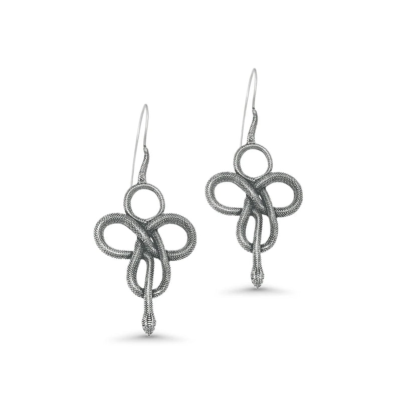 Silver Viking-style snake earrings photographed from side angle, highlighting twisted loop design and antique tribal finish.