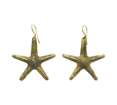 Elegant gold starfish earrings displayed on white background, featuring detailed texture and ocean-inspired design.