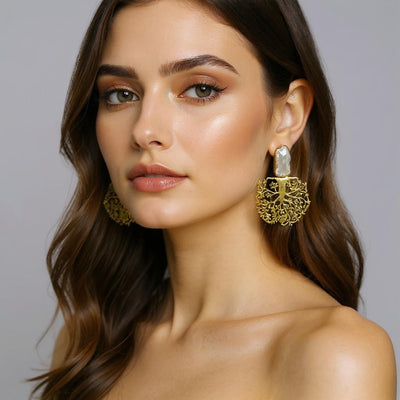 Model wearing gold tree-shaped earrings with pearls, showcasing elegant and handcrafted design by INNERPLANE.