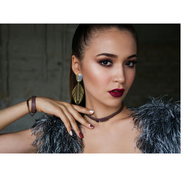 Woman wearing INNERPLANE pearl palm leaf stud earrings, showcasing their statement look and sophisticated appeal.