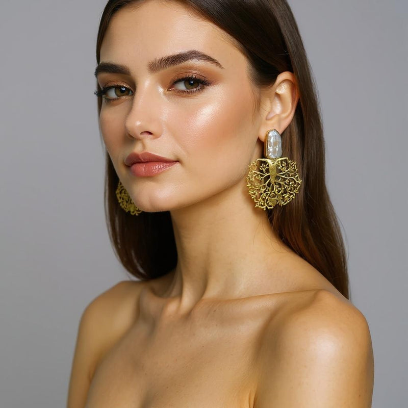 gold plated statement earrings with natural pearl studs and intricate tree of life design.