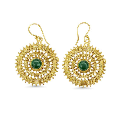Gold round mandala earrings with green stone centerpiece displayed on white background, featuring intricate tribal-inspired geometric detailing.