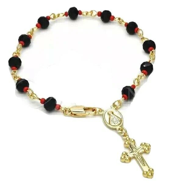 Side angle of gold cross rosary bracelet featuring red and black evil eye beads.