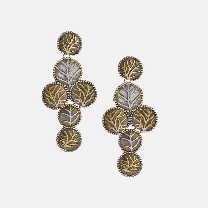 Close-up of Two Tone Gold and Silver Leaf Earrings with intricate detailing.