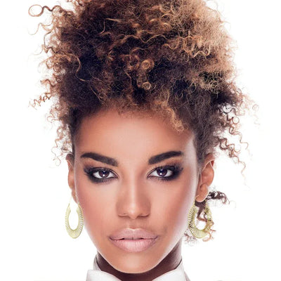 Model showcasing extra large gold tracks statement hoop earrings for a modern bold look.