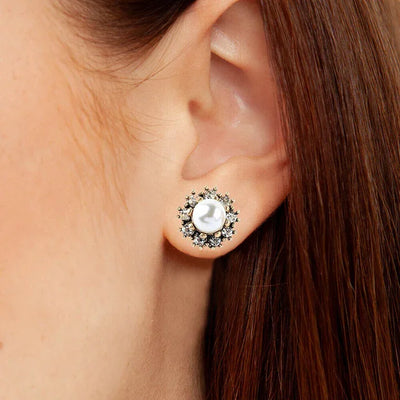 Close-up of Pearl and Diamond Cluster Stud Earrings worn on ear showing shine and detailing.
