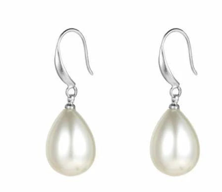 Close-up of polished pearl drop earrings in silver finish.