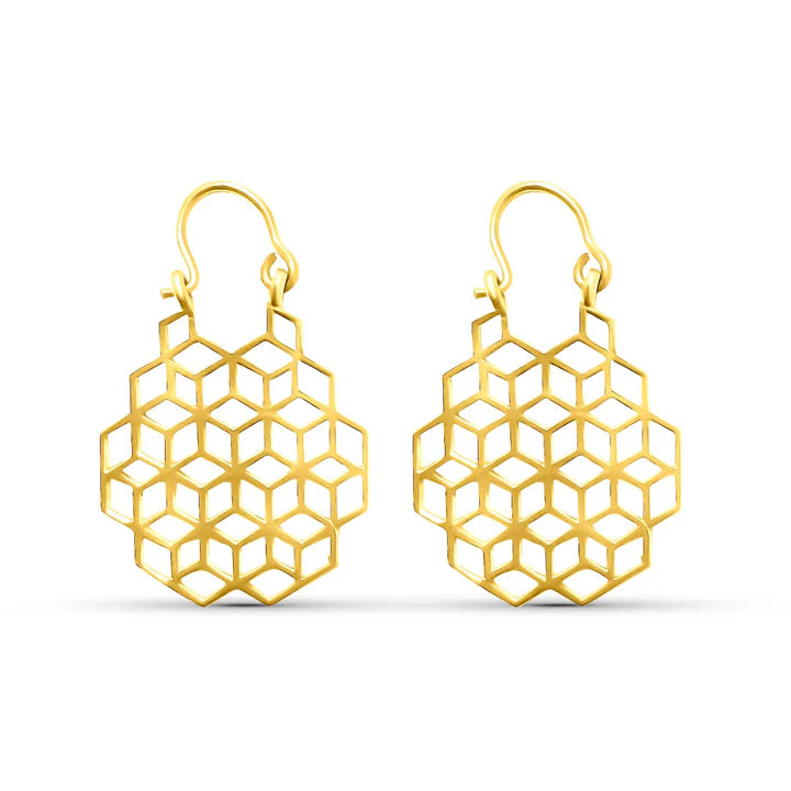 Minimal display of geometric honeycomb gold drop earrings, elegant statement jewelry.