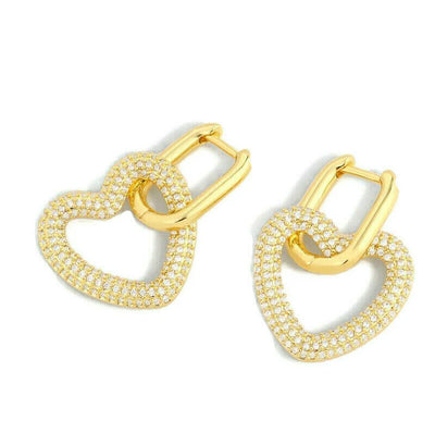 Flat lay of Brilliant Gold Diamond Heart Hoop Earrings arranged side by side.