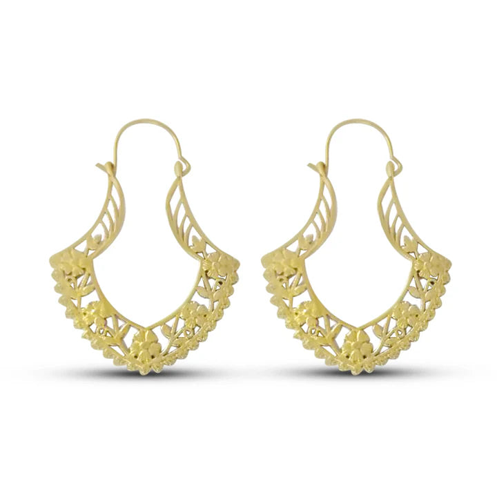 Front view of gold filled tribal flower hoop earrings with intricate floral carving.