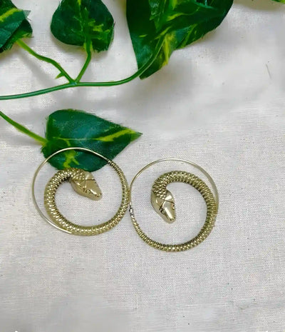 Gold snake threader earrings displayed on fabric background, minimalist design.