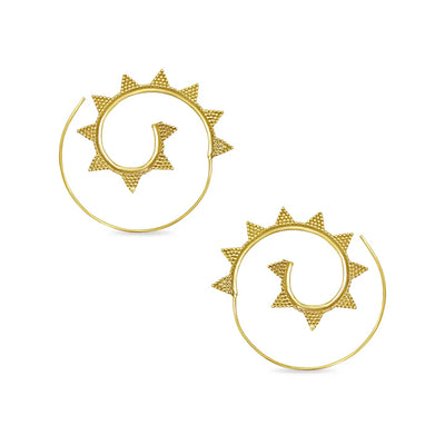 Minimal display of golden spiral sun earrings, geometric handcrafted accessory.