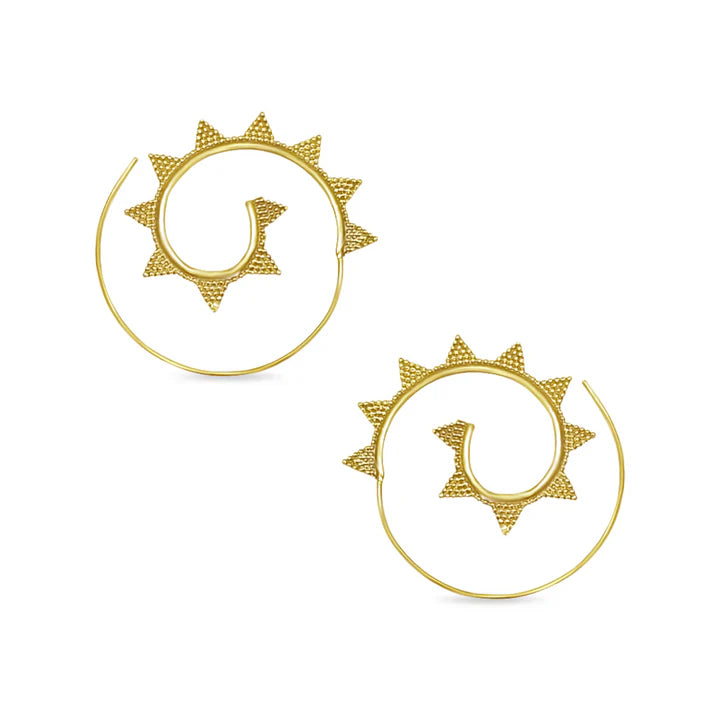 Minimal display of golden spiral sun earrings, geometric handcrafted accessory.