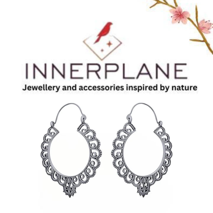 Innerplane brand logo with silver floral hoop earrings displayed elegantly.