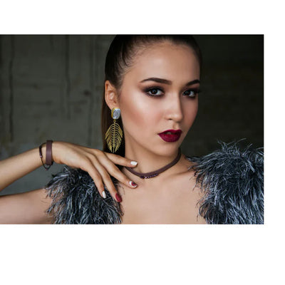 Model wearing iridescent pearl leaf drop earrings, bold and glamorous accessory.