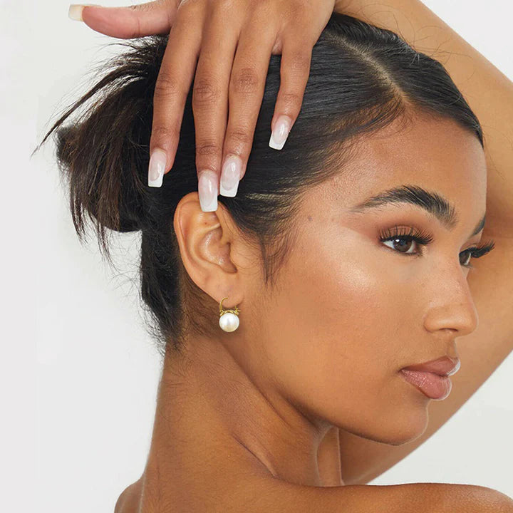 Model styled with Pearl Drop Gold Huggie Hoop Earrings for everyday elegance.