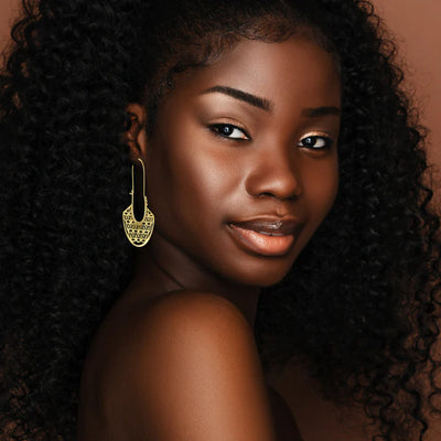 Model wearing Flower Of Life Gold Metal Drop Earrings styled for a modern boho look.
