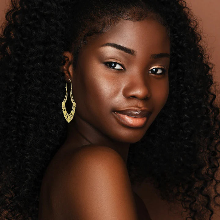 Model wearing gold filled tribal flower hoop earrings styled with elegant bohemian look.