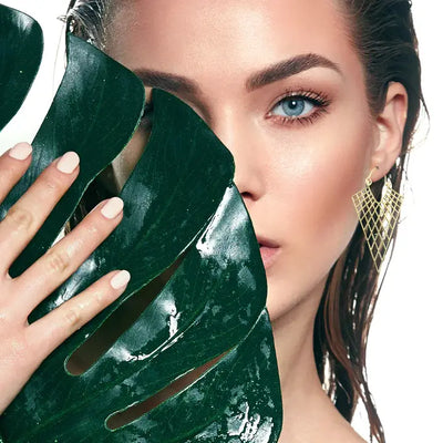 Model wearing gold net drop hoops earrings for a bold modern look.