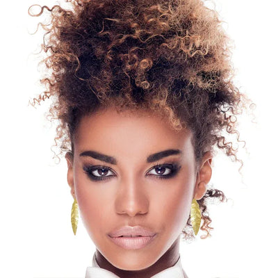 Model wearing Laurel Gold Leaf Drop Statement Earrings for an elegant bohemian look.