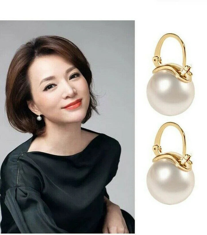 Model wearing Pearl and Gold Drop Huggie Hoop Earrings with elegant style.