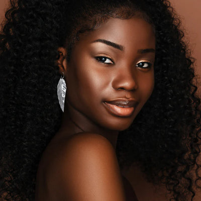 Model wearing silver guava leaf drop earrings styled with minimal elegant look.