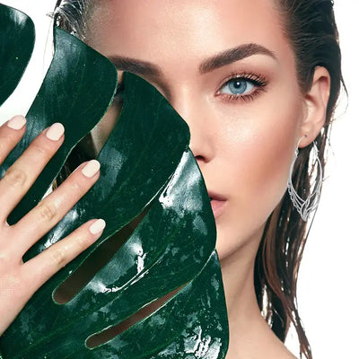 Model styling wave caviar geometric hoop earrings with sleek contemporary look.