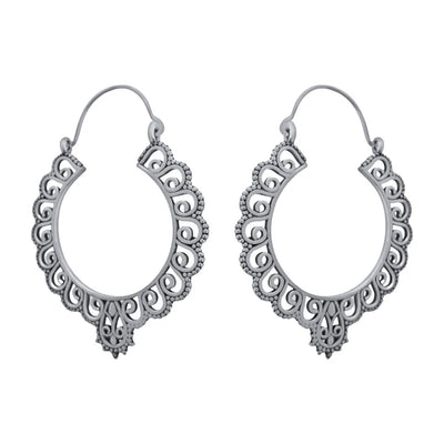 Pair of silver floral hoop earrings captured from side angle showing intricate pattern.
