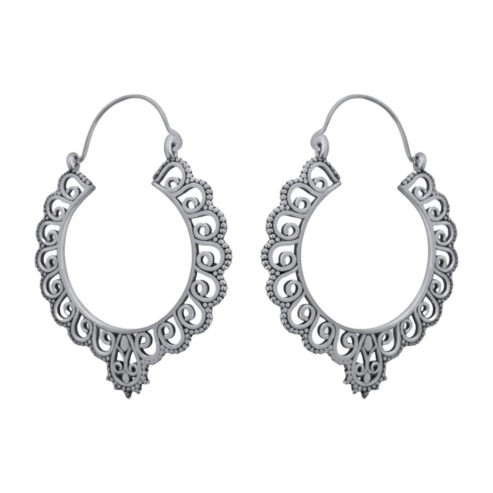 Pair of silver floral hoop earrings captured from side angle showing intricate pattern.
