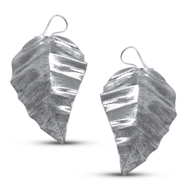 Pair of silver guava leaf drop earrings showing handcrafted surface texture and natural curve.