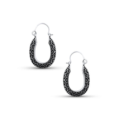 Pair of sterling silver swirl black wavy design oval hoop earrings showing artistic curved texture.