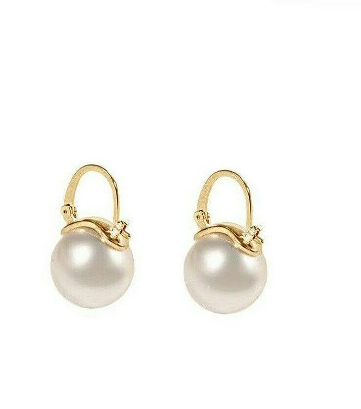 Front view of Pearl and Gold Drop Hoop Earrings featuring classic huggie hoop design.