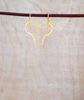 Front view of gold serpentine glow skinny snake drop earrings with curved loop design.