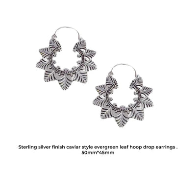 Angled view of handcrafted silver Evergreen Creole Leaf earrings highlighting intricate design.
