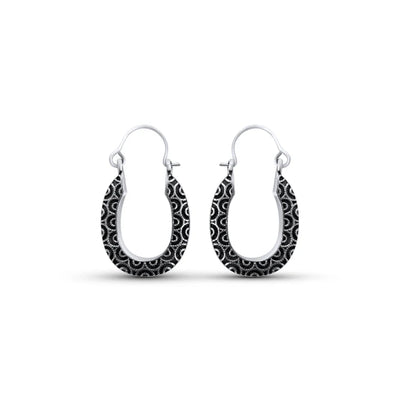 Front view of sterling silver swirl black wavy design oval hoop earrings with engraved detailing.