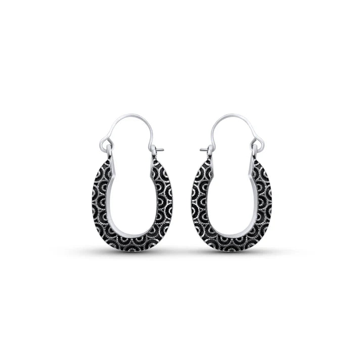 Front view of sterling silver swirl black wavy design oval hoop earrings with engraved detailing.